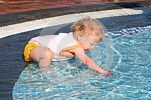 Toddler playing in pool