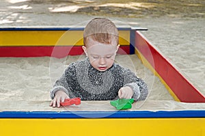 Toddler playing in sandbox