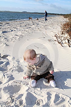 Toddler playing on sandy beach