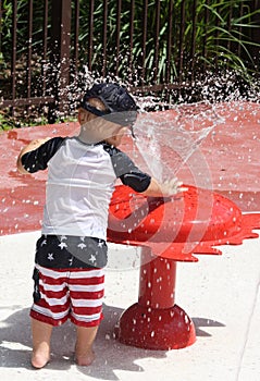 Toddler playing in some water