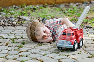 Toddler Playing with a Toy Fire Truck Outside - Series 5