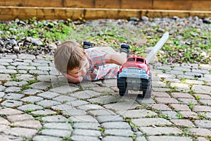 Toddler Playing with a Toy Fire Truck Outside - Series 8