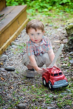 Toddler Playing with a Toy Fire Truck Outside - Series 2