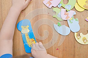 Toddler playing with toy numbers on the floor.