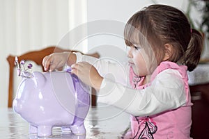 Toddler Putting Money in Savings