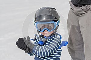 Toddler Ready to Ski Safely with Helmet and Harness