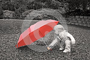 Toddler with red umbrella