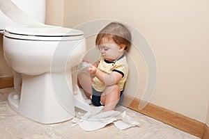 Toddler ripping up toilet paper