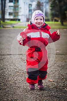 Toddler`s winter walk in urban yard