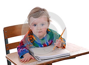 Toddler Sitting At School Desk