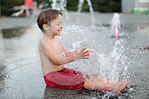 Toddler and a splashing water fountain