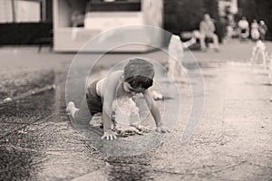 Toddler in a splashing water fountain