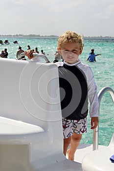 Toddler standing on a boat