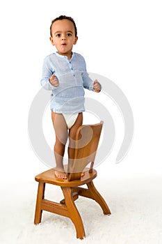 Toddler standing on chair