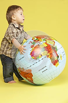 Toddler In Studio With Globe
