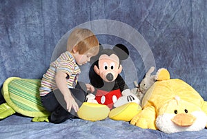 Toddler with stuffed animals