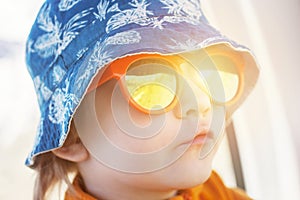 Toddler in sunglasses in cap