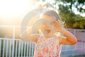 Toddler at sunset making faces