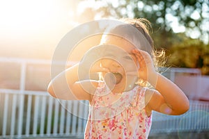 Toddler at sunset making faces