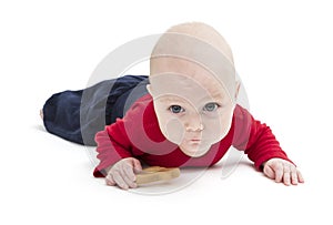 Toddler with toy and red shirt crawling