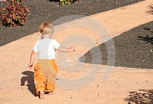 Toddler walking along path