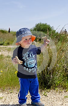 Toddler wearing a hat at nature reserve