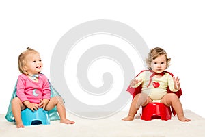 toddlers sitting on potties photo