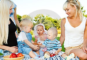 Toddlers and their moms having lunch