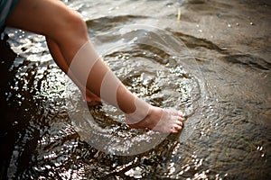 Toes dipping in water photo