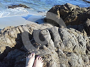 Toes on rock, rocky beach