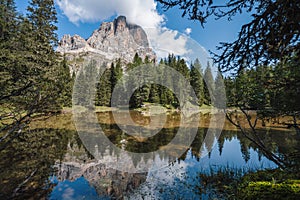 Tofana di Rozes reflected in small pond on Passo Falzarego, Dolomites in the Province of Belluno, Veneto, Italy