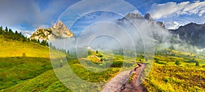 Tofane mountain range at sunny foggy morning. Panorama from Falzarego pass. Dolomites mountains, Italy, Europe.