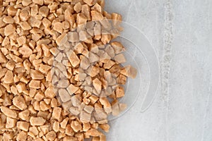 Toffee bits on a gray marble cutting board