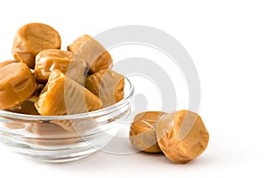 Toffee caramel candies in a crystal bowl isolated