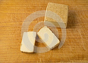 Tofu Cheese Isolated, Smoked Vegan Cheese Slice, Sliced Soya Bean Curd, Soy Protein or TSP photo