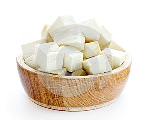 Tofu cubes in wooden bowl