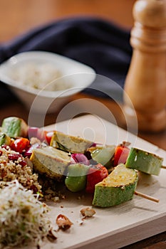 Tofu kebab on millet with almonds, millet calls and cranberries