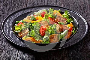 Tofu salad with greens and vegetables in bowl