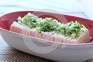 Tofu salad with soy sauce, vinegar, sesame oil and green onion slice this food are the combination form Japanese and Chinese.