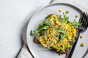 Tofu scramble toast with greens on rye bread. Healthy vegan food concept