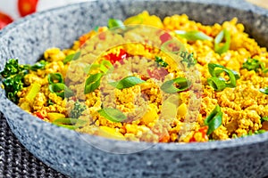 Tofu scramble with vegetables in a pan. Vegan Alternative Omelet