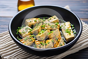 tofu steaks in a bowl soaking in teriyaki marinade