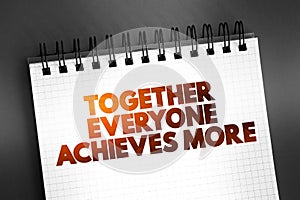 Together Everyone Achieves More text quote on notepad, concept background