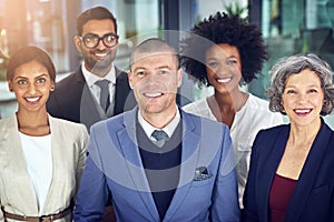 Together, success is a given. Portrait of a team of corporates standing together in an office.