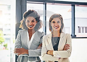 Together, well be making it great in business. Portrait of two confident young businesswomen standing together in an