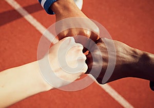 Together weve got this. a team of athletes giving each other fist bumps.