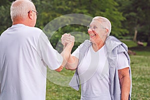 together we workout better- senior couple exercise and having fun together.