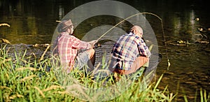 Togetherness. happy fishermen friendship. big game fishing. relax on nature. Two male friends fishing together. retired