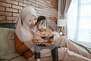 Togetherness of little girl and mother stared screen of smartphone
