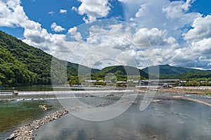 Togetsu-kyo bridge over katsuragawa river with colourful forest mountain background in Arashiyama district.